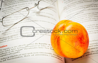 Nectarine and reading glasses