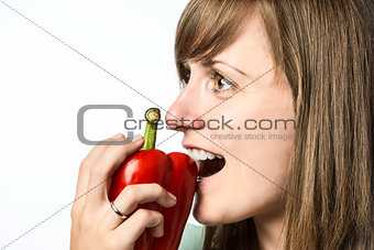 Woman biting in pepper