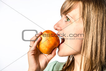 Young girl biting into apple