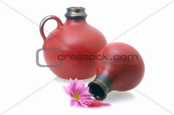 two wine jugs with a flower