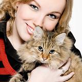 Portrait of a blond curly woman with cute kitten