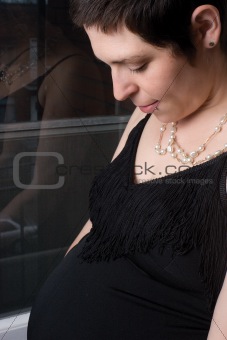 Pregnant women in front of window