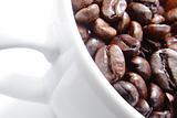 White cup of coffee beans.