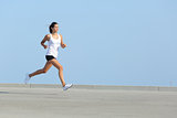 Beautiful woman running with the sky in the background