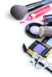 makeup set (shadows, lipstick, brush) on a white background