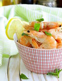 shrimp cooked with lemon and basil on a wooden table