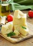 Hard natural parmesan cheese on a wooden board