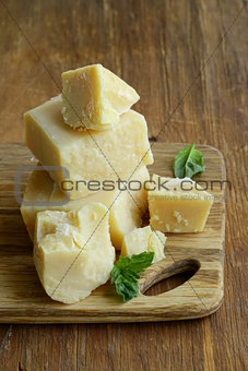 Hard natural parmesan cheese on a wooden board