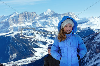 Children on winter  mountain background. Gardena Pass, Italy.