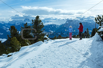 Family walking on winter mountain slope