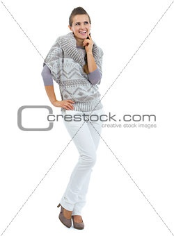 Full length portrait of thoughtful young woman in sweater lookin