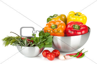Fresh bell peppers and herbs in bowls