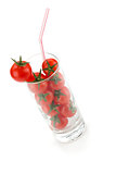 Cherry tomatoes in glass with drinking straw