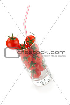 Cherry tomatoes in glass with drinking straw