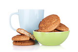 Cup of milk and bowl with cookies
