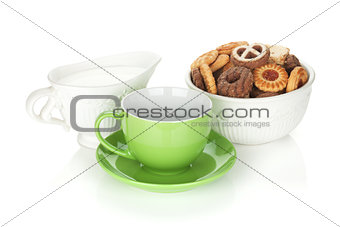 Various cookies, milk and tea cup