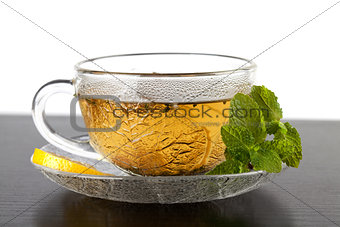 Cup of green tea with lemon and mint