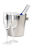 Champagne bottle in ice bucket and two empty glasses