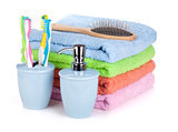 Four toothbrushes, liquid soap, hairbrush and colorful towels