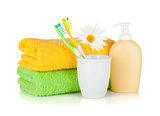Toothbrushes, liquid soap, towels and flower