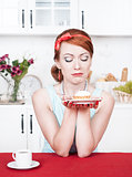 Sad beautiful woman looking on cake