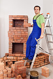 Worker building masonry heater