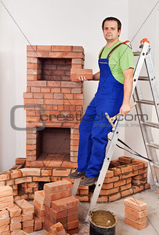 Worker building masonry heater