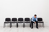 Desperate businessman or employee sitting alone