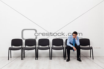 Desperate businessman or employee sitting alone