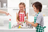 Do the dishes - kids ordered to help in the kitchen