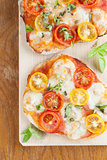 Mini pizzas with mozzarella and cherry tomatoes