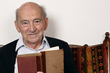 Portrait of a grandpa reading a book