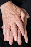 Crossed hands of an old senior