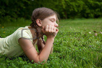 Little girl thinking in a park