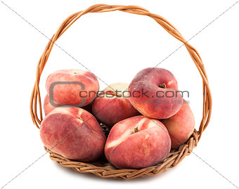 Paraguayos flat peaches in wicker basket