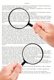 Hands holding magnifying glass reading document
