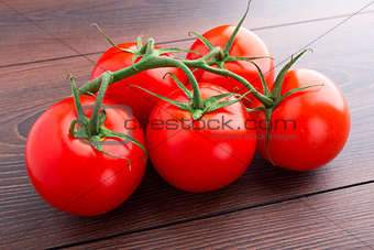Tomatoes bunch on wooden table