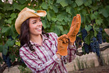 Young Adult Female Wearing Cowboy Hat and Gloves in Vineyard