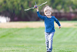 boy playing toy plane