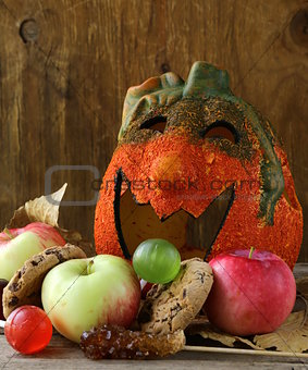 Halloween pumpkin Jack O'Lantern with fruit and sweets