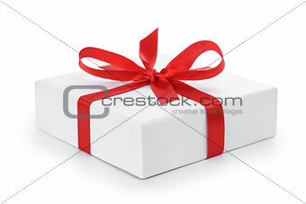 white textured gift box with red ribbon bow