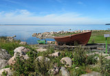 Fishing boat on the shore on a wooden platform