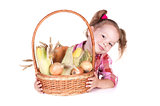 Little girl with basket of vegetables