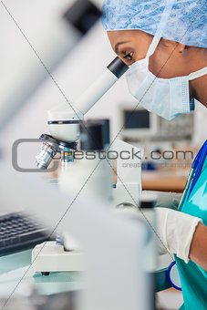 Asian Woman Doctor Scientist Using Microscope In Laboratory