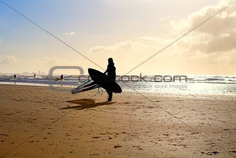 silhouette of kitesurfer on sand beach