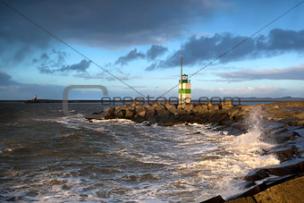 North sea waves and lighthouse in Ijmuiden, Holland
