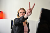 Business woman doing victory sign