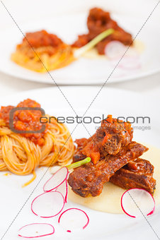 pasta with pork ribs sauce on polenta bed
