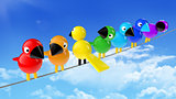 rainbow colored birds on a cable in front of blue sky