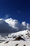 Snowy mountains and blue sky with clouds